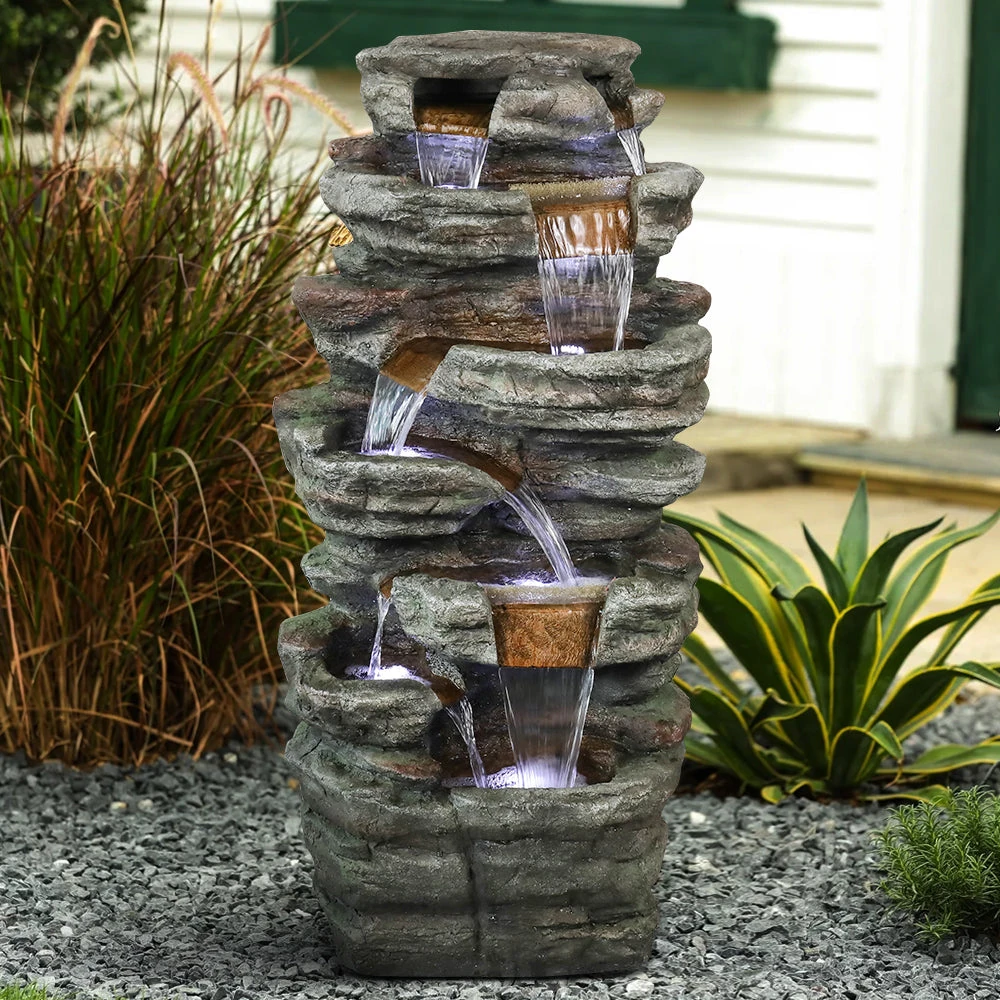 Close-up of a bird bath solar bubbler fountain spout with water droplets sparkling in sunlight