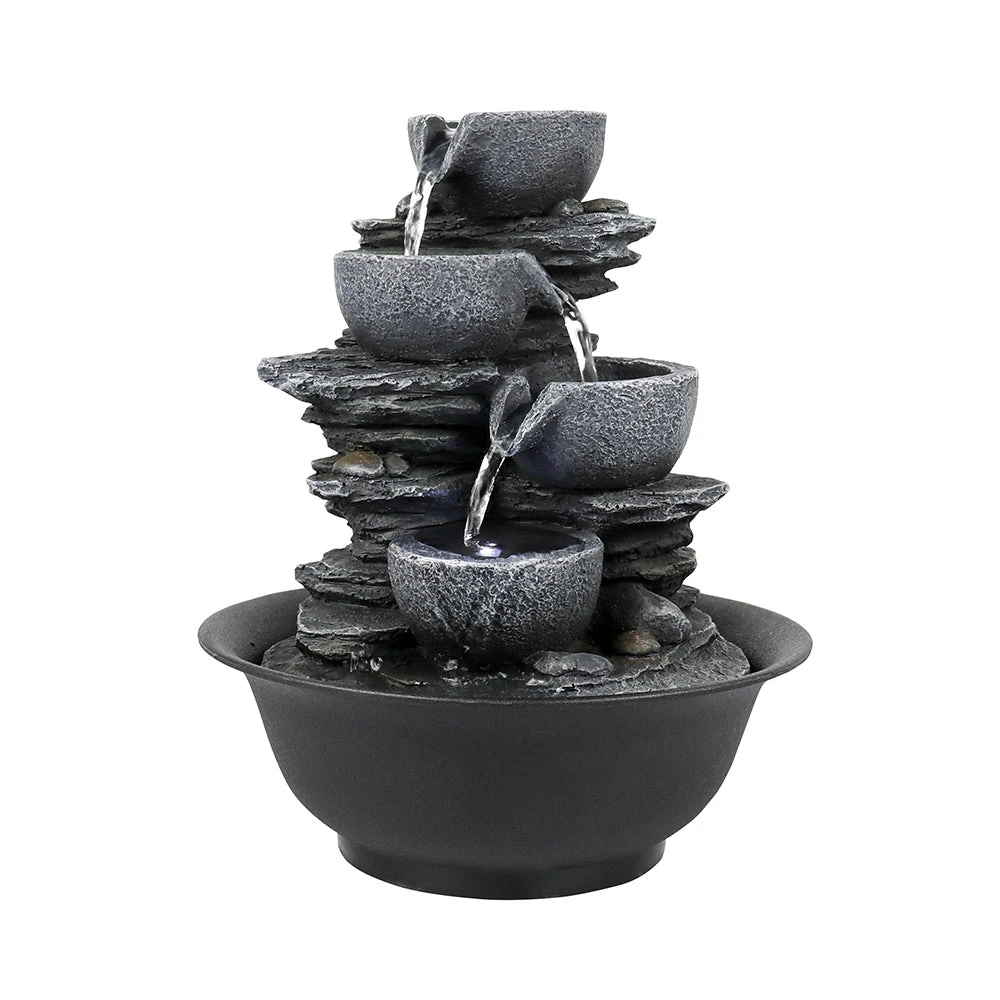A bird bath solar bubbler in action with multiple birds gathered around the moving water in a sunny garden