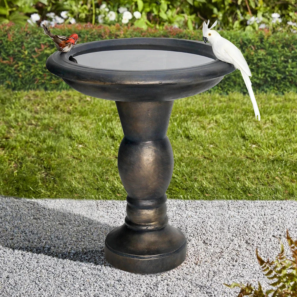 concrete squirrel bird bath with antique pedestal design in garden setting