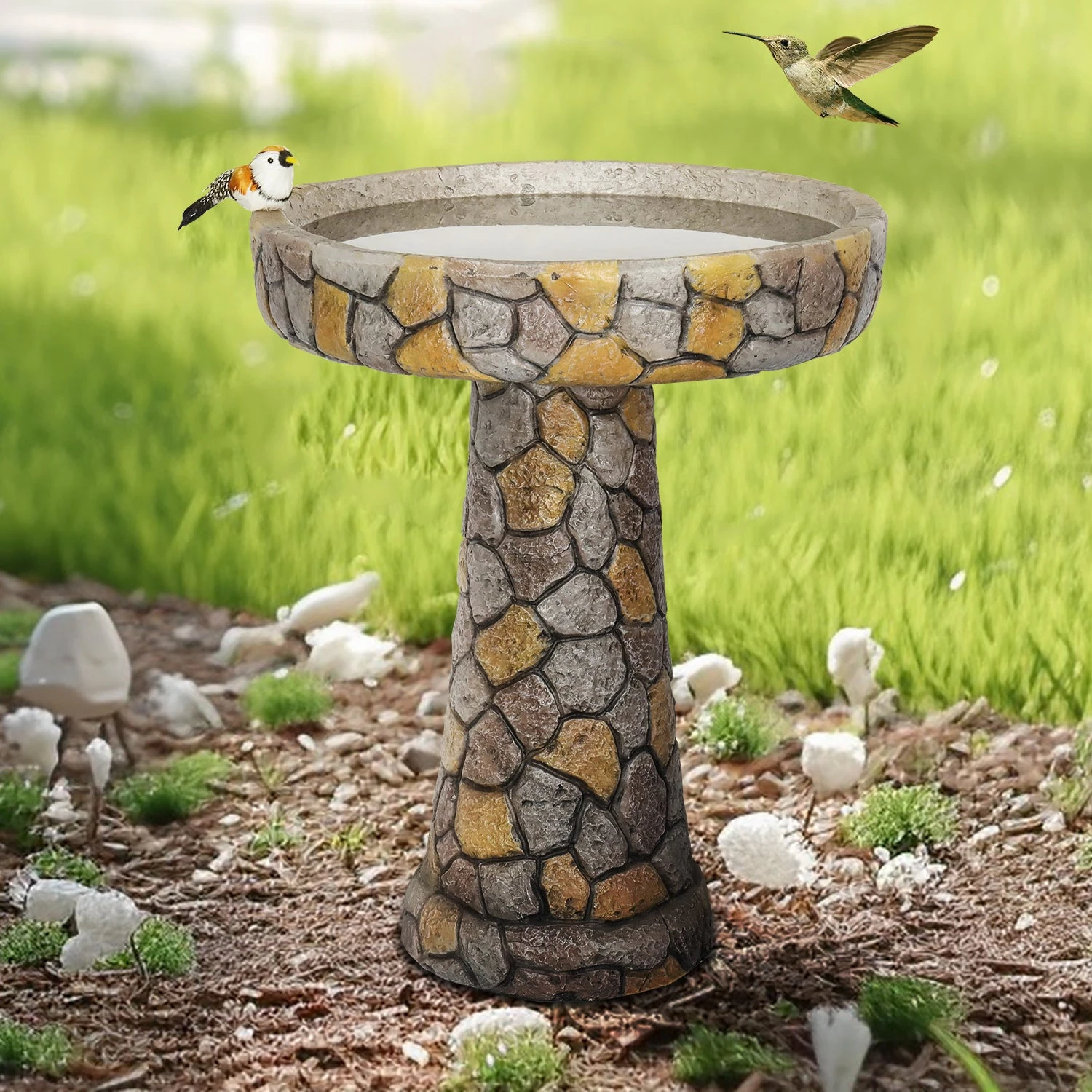 large copper bird bath with mosaic stone design in a garden setting